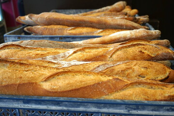 Traditional crusty French baguettes bread in a bakery shop. French bakery concept. Freshly baked...