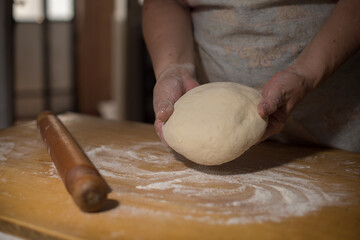hands preapring pastry on wooden table 