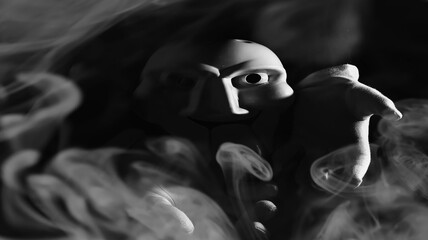 White scary mask on a black background with whites hand.