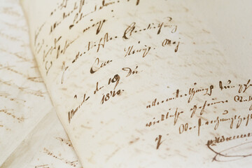 closeup of old handwriting; vintage paper background