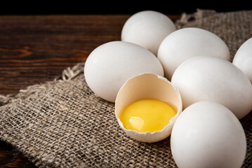 Eggs on dark wooden background.