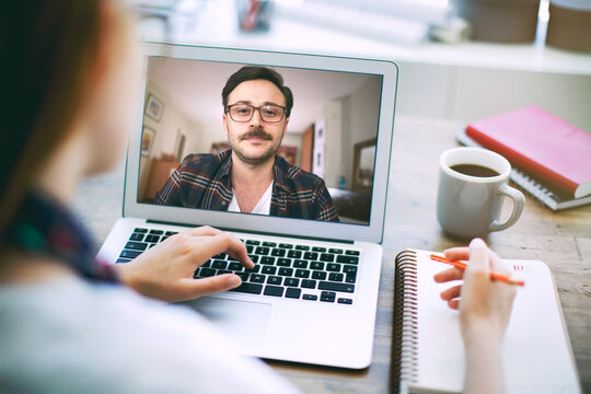 Woman talking to her colleague about plan in video conference