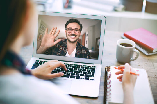 Woman talking to her colleague about plan in video conference