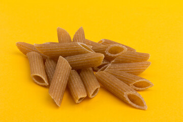 Pasta from hard wheat. Italian pasta on yellow background,  place for text.