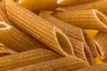 Pasta from hard wheat. Italian pasta on yellow background,  place for text.