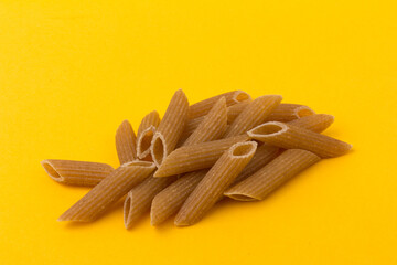 Pasta from hard wheat. Italian pasta on yellow background,  place for text.