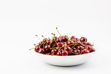 fresh red cherry fruit in plate  isolated on white background