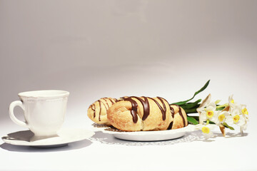 French breakfast on the table. Coffee croissant with chocolate and a decanter with cream. Fresh pastries and decaffeinated coffee.