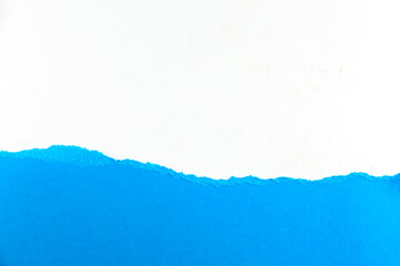 divided halves of the sheet of blue ripped paper on white background