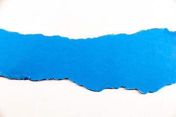 divided halves of the sheet of blue ripped paper on white background