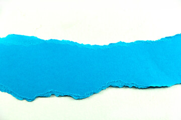 divided halves of the sheet of blue ripped paper on white background