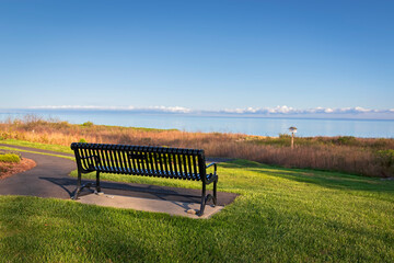 Metal park bench overlooking ocean