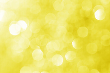 Obraz premium abstract defocused yellow bokeh sparkling light glitter background. for wallpaper backdrop and template.