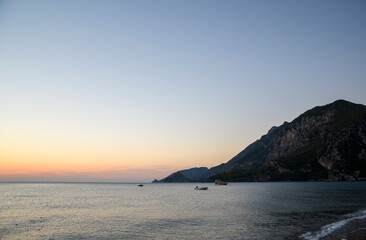 Beautiful orange sunrise on the Mediterranean Sea shore at Olympos coast, Cirali village, Turkey