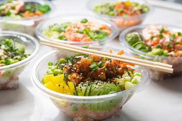 Closeup of Japanese takeaway food, poke bowls.