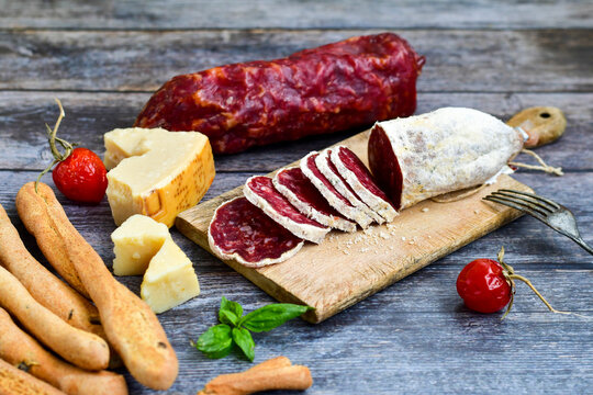  Italian  artisan dred salami. parmesan cheese  and sausage on wooden board