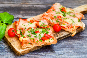 Assorted sliced italian roman   style pizza.  with parmesan cheese,  ham,  mushrooms and tomato sauce 