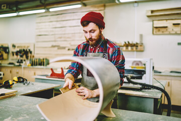 Confident hipster working on construction using equipment