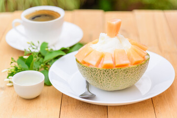 Melon Bingsu with Sweetened Condensed Milk on wood table 