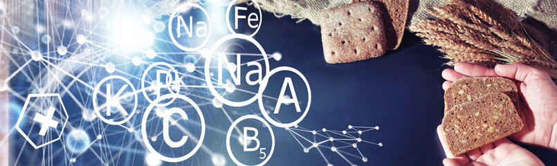 Fresh loaves of bread with wheat and gluten on a black table. Bakery and grocery concept. Fresh, healthy sorts of rye and white loaves food closeup. Fresh homemade bread with cereals.