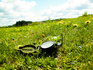 Compass on grass - traveling, exploration and navigation.