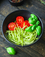 zucchini spaghetti salad tomato vegetables Menu concept serving size. food background top view copy space organic healthy eating keto or paleo diet