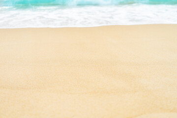 Fototapeta na wymiar close up sand beach with blue sea wave background