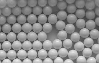 Closeup of white plastic bb's lined up on flat background