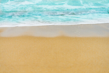 Naklejka na ściany i meble close up sand beach with blue sea wave background