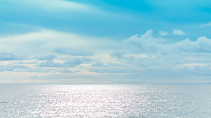 Obraz na płótnie Canvas sea beach and reflection in water, cloudy blue sky background