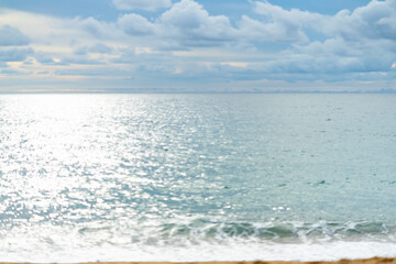 Fototapeta na wymiar sea beach and reflection in water, cloudy blue sky background