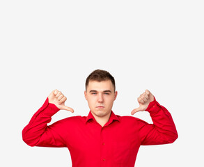 Dislike gesture. Failure mistake. Disappointed man in red shirt showing thumbs down isolated on...