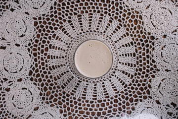 Latte coffee on the table with knitted white napkin on the cafe. Place for text