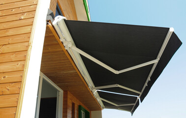 Outdoor high quality automatic sliding canopy retractable roof system, patio awning for sunshade of a modern wooden house. - obrazy, fototapety, plakaty