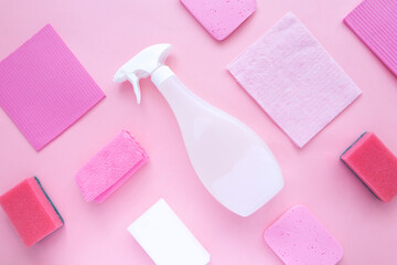 Detergents and cleaning products agent, sponges, napkins and rubber gloves, pink background. Top view