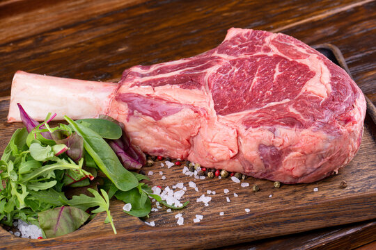 Raw ribay on the bone with fresh greens and spices
