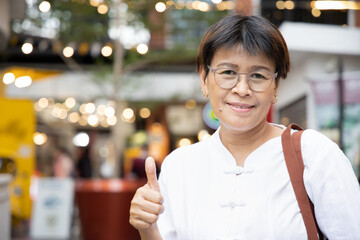 middle aged aunt, old woman showing thumb up gesture