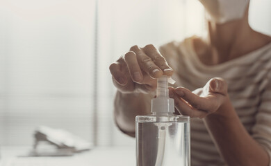 Obraz na płótnie Canvas Woman applying sanitizer on her hands