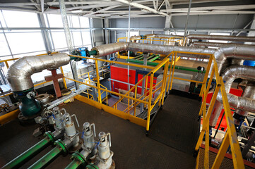 Fototapeta na wymiar Complex system of tanks, pipelines, pumps and valves of boiler-house