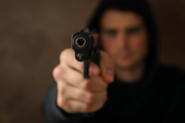 Man hold pistol. Selective focus. Robber. Violence