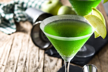 Green appletini cocktail on wooden table
