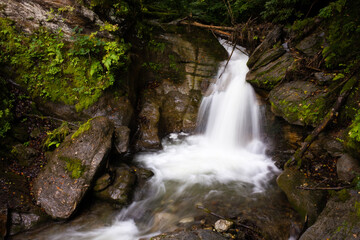 Beautiful small isolated waterfall in the Alpine mountains