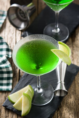 Green appletini cocktail on wooden table
