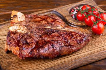 Steak baked on coals with pepper and salt