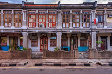 Traditional Malaysian colonial houses in disrepair on a street in Georgetown, Penang, Malaysia