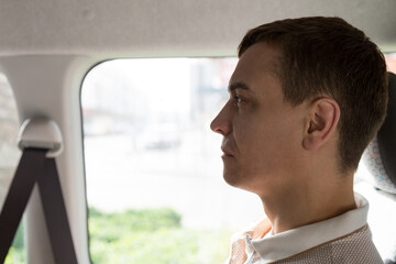 Fototapeta premium Passenger public transport in Europe. A 30-35 year old man sits in a taxi near the window.