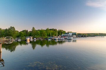 Fototapeta na wymiar Panoramic view on Ukiel lake with marina at sunset time.