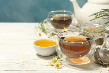Composition with chamomile tea on white wooden table