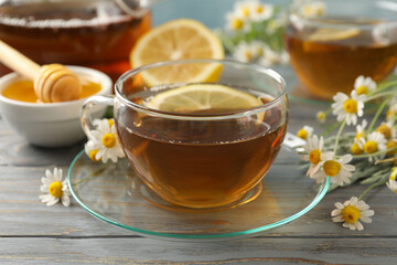 Composition with chamomile tea on gray wooden background