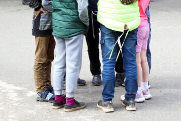 Children's feet, the company of children at the stadium